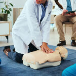 Certified Nurse Assistant training student practicing patient care skills during CNA classes