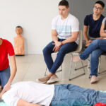 Student practicing patient care skills during CNA training while learning how to become a CNA