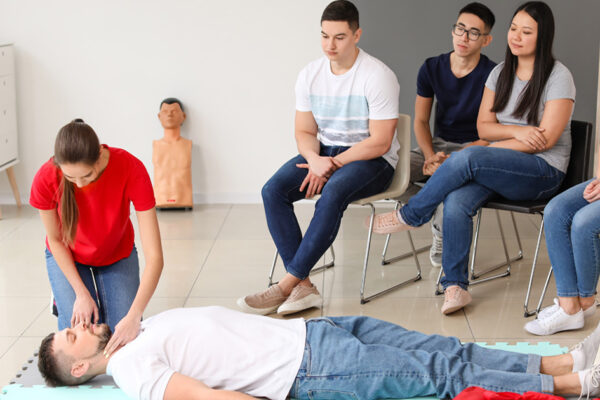 Student practicing patient care skills during CNA training while learning how to become a CNA