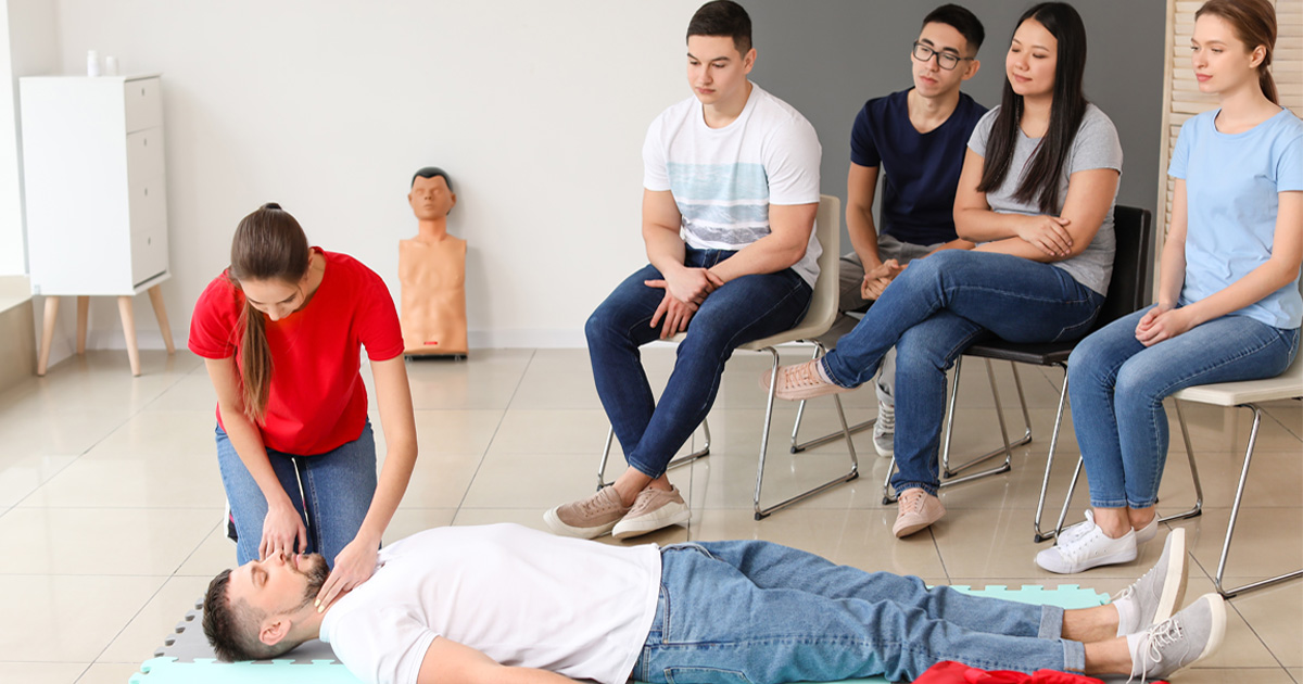 Student practicing patient care skills during CNA training while learning how to become a CNA