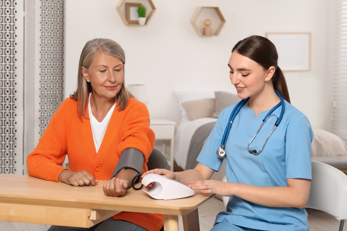 Medical assistant taking a patient's blood pressure demonstrating core medical assistant skills during patient care