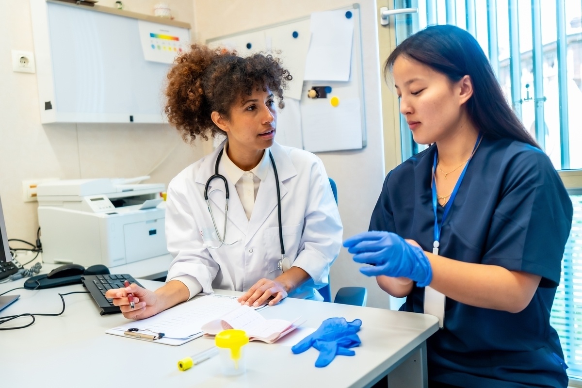 Medical assistant in scrubs working with a physician while seeking medical assistant jobs in NYC